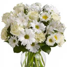 White mixed bouquet in a clear glass vase