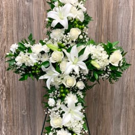 White floral cross on a standing easel