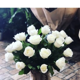 Bouquet of white roses wrapped in burlap