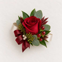 Red rose corsage with ribbon and berries