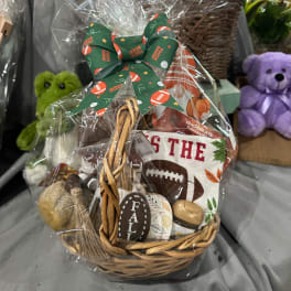 Basket gift set with football decor and a green bow