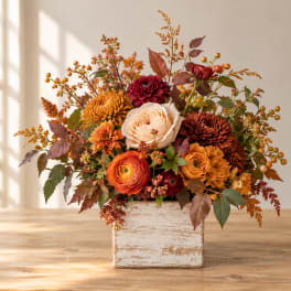 Autumn floral arrangement in a rustic white wooden box