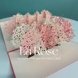Pop-up greeting card with pink and white floral cutouts