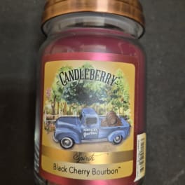 A jar candle labeled Candleberry Black Cherry Bourbon