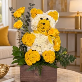 Yellow and white flower teddy bear in a wooden box with roses