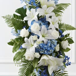Tall blue and white floral standing spray on an easel
