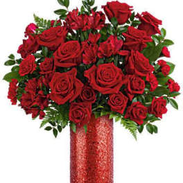 Red roses and red alstroemeria in a glittery red vase