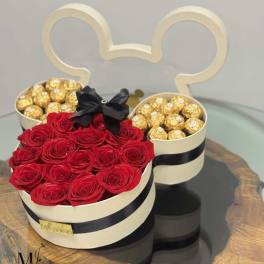 Red roses and gold chocolates in a Mickey-shaped gift box with a black bow