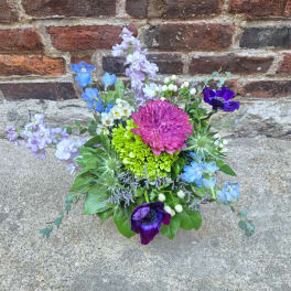 Colorful mixed bouquet with blue, purple, pink, and green flowers