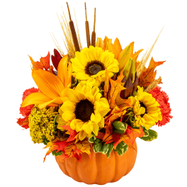 Autumn floral arrangement in a pumpkin container with sunflowers and orange lilies