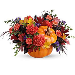 Autumn floral arrangement with pumpkins and mixed flowers