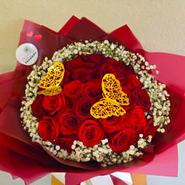 Bouquet of red roses with white baby's breath and decorative butterfly picks