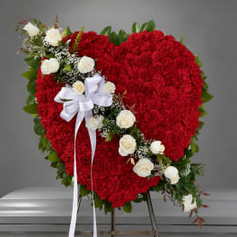Heart-shaped red floral spray with white roses on an easel