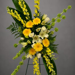 Yellow and white floral standing spray on an easel