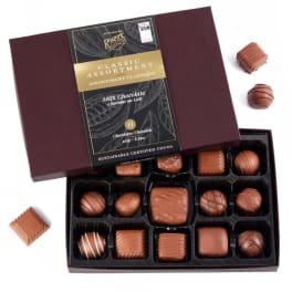 Box of assorted milk chocolates with several pieces outside the open lid