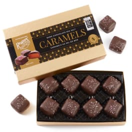 Box of dark chocolate sea salt caramels with pieces outside the box