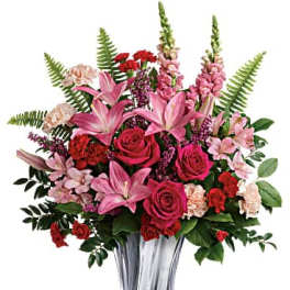 Pink and red mixed bouquet in a clear glass vase