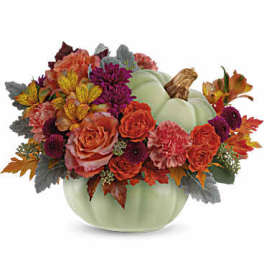 Pumpkin-shaped vase with orange and purple flowers