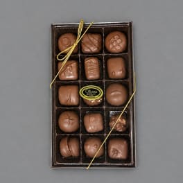 Box of assorted chocolates tied with a gold ribbon