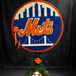 New York Mets floral sign with orange ribbon accents on a stand