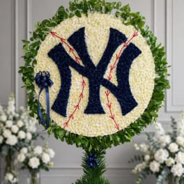 Round floral tribute with a New York Yankees logo and blue ribbon