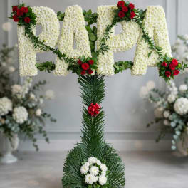 Floral standing tribute with white flower letters and red roses