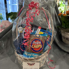 Gift basket with snack bags wrapped in clear plastic and red ribbon