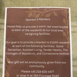 Printed donation flyer on a woven surface asking to sponsor a resident.