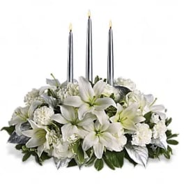 White floral centerpiece with three tall candles