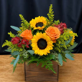 Sunflower and orange rose arrangement in a wooden box