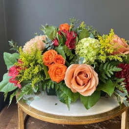 Mixed bouquet of roses, hydrangea, and other blooms on a table