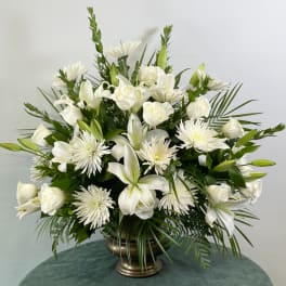 White floral arrangement in a bronze vase