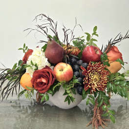 Fruit arrangement with roses, chrysanthemums, and a white bowl vase