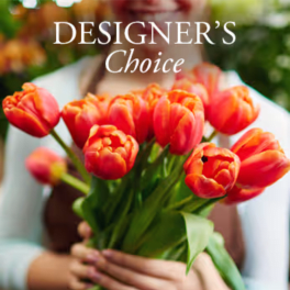 Bouquet of orange tulips held in front of a blurred person