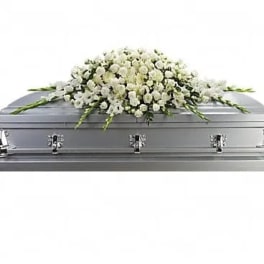 White floral spray on a silver casket