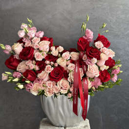 Large bouquet of red and blush roses in a silver vase