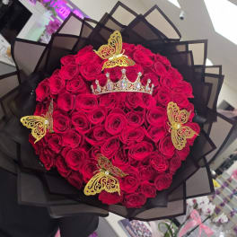 Bouquet of red roses with gold butterfly and crown decorations