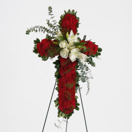 Red and white floral cross on a stand