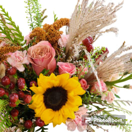 Bouquet with a sunflower, pink roses, and dried grasses