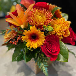 Bouquet of red roses, orange lilies, and yellow chrysanthemums