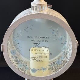 Round memorial lantern with a candle and floral quote insert