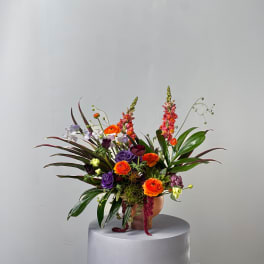 Colorful mixed flower arrangement in a round vase
