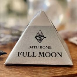 Triangular box labeled "Bath Bomb Full Moon" with an eye logo