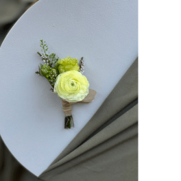 Small boutonniere with pale yellow flowers on a white background