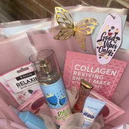 Gift basket with skincare items and a butterfly topper