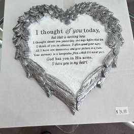 Silver heart-shaped memorial plaque with a printed sympathy verse