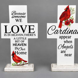Two white memorial cross signs with cardinal and sympathy text