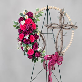 Floral heart wreath with pink and purple roses on a stand
