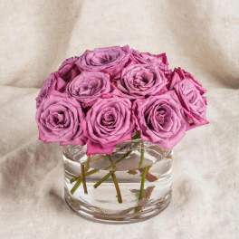 Pink roses arranged in a clear glass vase