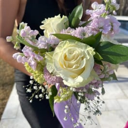 Handheld bouquet with white roses and pale lavender flowers